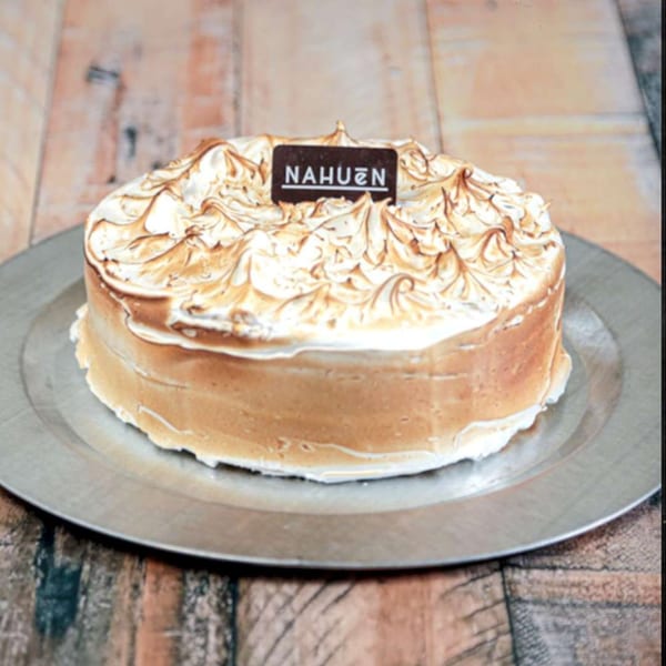 NAHUEN Gourmet Market's dulce de leche cake with toasted meringue topping and a branded chocolate plaque.