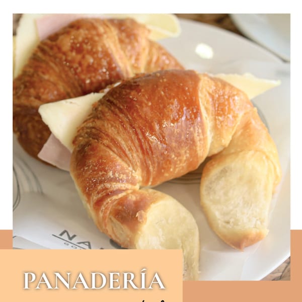 Two golden-brown croissants filled with ham and cheese on a white plate.